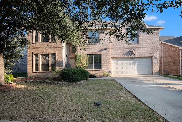 view of front of home with a front yard and a garage