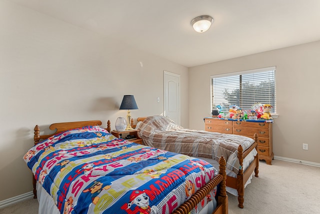 bedroom featuring light carpet