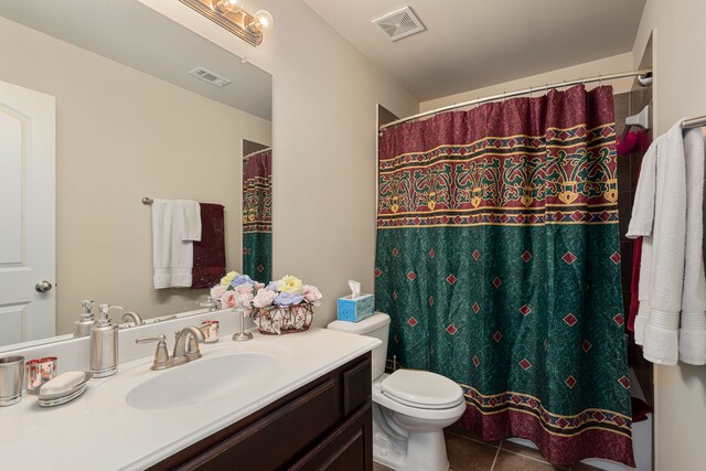 bathroom with vanity, toilet, a shower with curtain, and tile patterned flooring