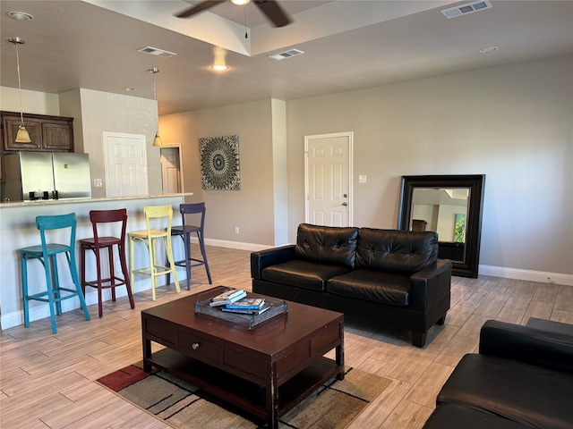 living room featuring light hardwood / wood-style floors and ceiling fan