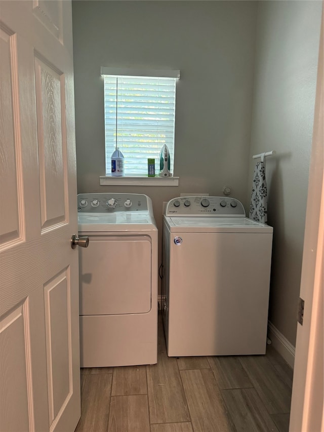 clothes washing area featuring light hardwood / wood-style floors and independent washer and dryer