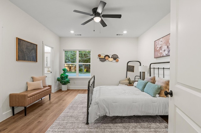 bedroom with connected bathroom, ceiling fan, and light wood-type flooring