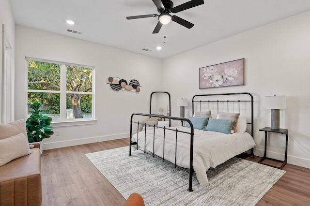 bedroom featuring light hardwood / wood-style floors and ceiling fan