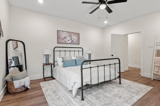 bedroom with ceiling fan and wood-type flooring