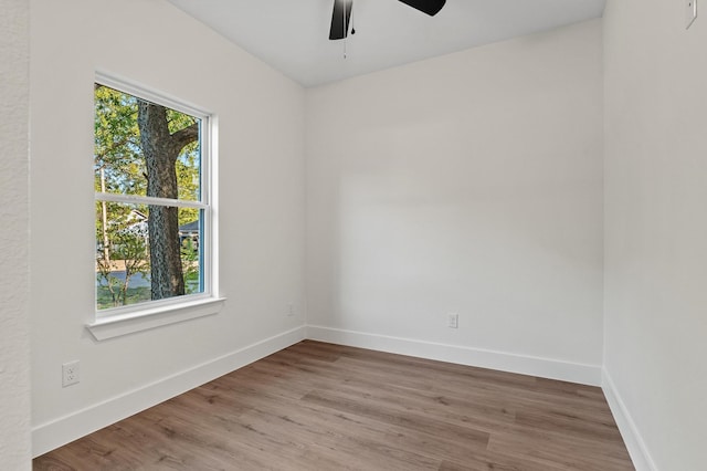 spare room with ceiling fan and hardwood / wood-style flooring