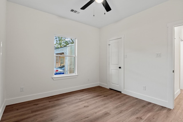 empty room with ceiling fan and light wood-type flooring