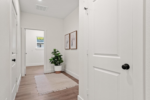 hallway with light wood-type flooring