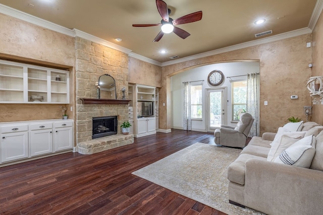 living room with ornamental molding, ceiling fan, a fireplace, and dark hardwood / wood-style flooring