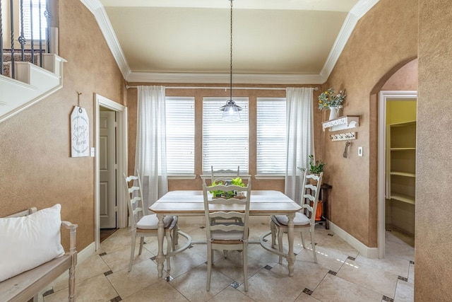 dining area featuring ornamental molding, light tile patterned flooring, and plenty of natural light