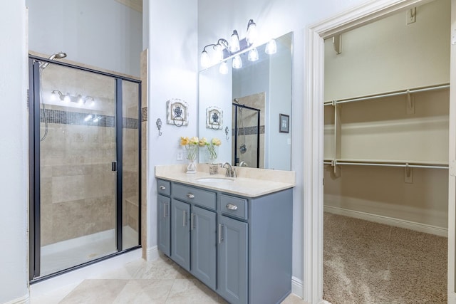 bathroom featuring vanity, tile patterned floors, and walk in shower