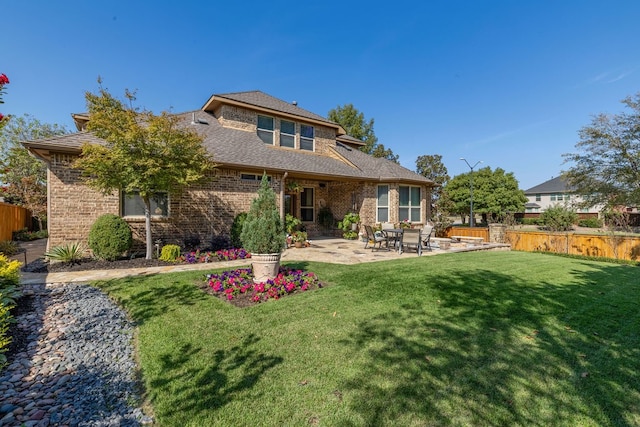 back of property with a patio area and a lawn