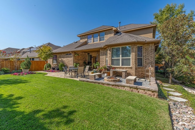 rear view of house featuring a patio and a lawn