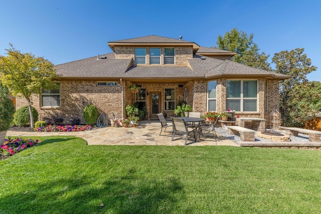 back of house featuring a patio area and a lawn