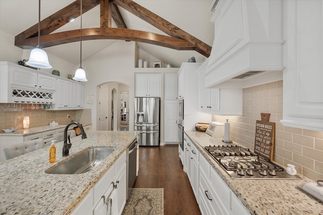 kitchen with sink, hanging light fixtures, white cabinetry, stainless steel appliances, and premium range hood