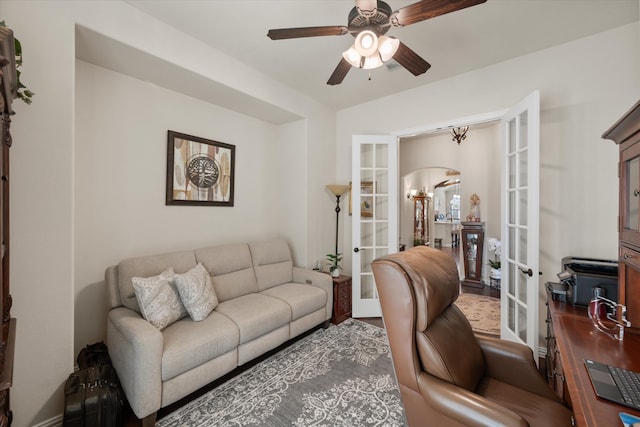 living room featuring french doors and ceiling fan