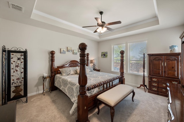 carpeted bedroom featuring ornamental molding, a raised ceiling, and ceiling fan