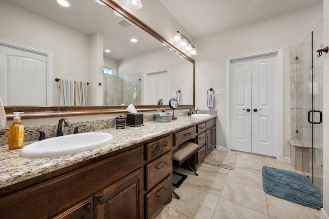 bathroom with vanity, tile patterned floors, and a shower with shower door