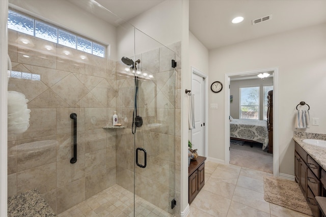 bathroom featuring vanity, walk in shower, and tile patterned flooring