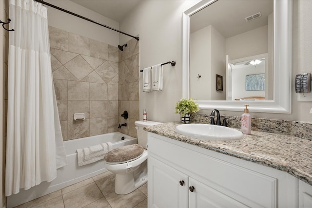 full bathroom featuring vanity, toilet, tile patterned floors, and shower / tub combo