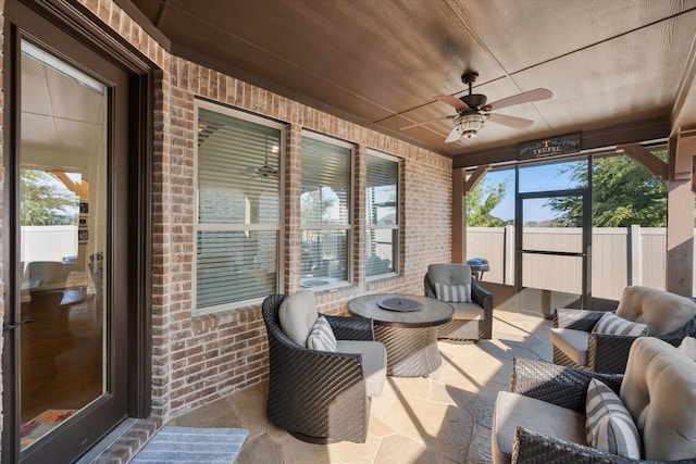 sunroom featuring ceiling fan, wooden ceiling, and plenty of natural light