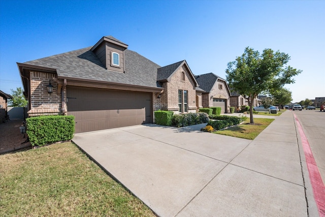 view of front of home featuring a front yard and a garage