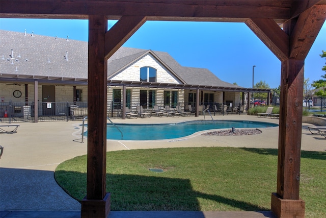 view of swimming pool featuring a patio and a lawn