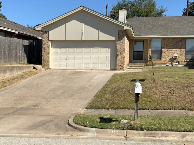 ranch-style home with a front lawn and a garage