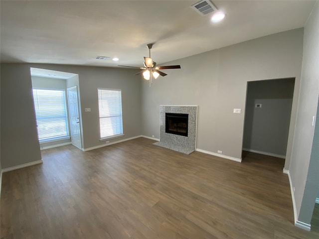 unfurnished living room featuring dark hardwood / wood-style floors and ceiling fan