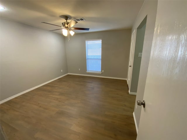 unfurnished room with ceiling fan and dark hardwood / wood-style flooring