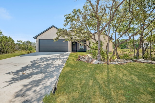 view of front facade with a front yard and a garage