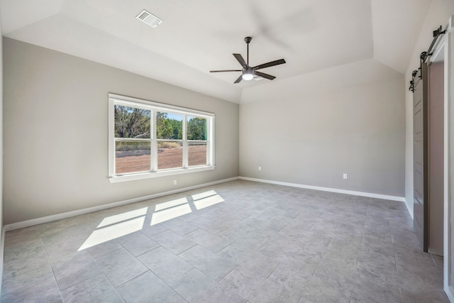 interior space with lofted ceiling, a barn door, and ceiling fan