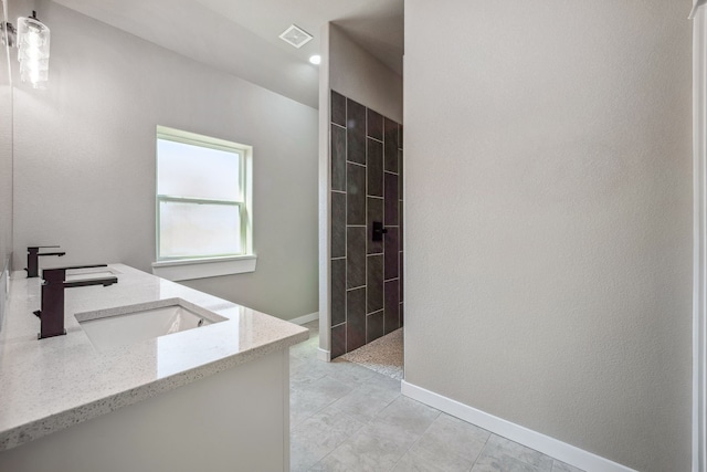 bathroom featuring vanity, walk in shower, and tile patterned floors