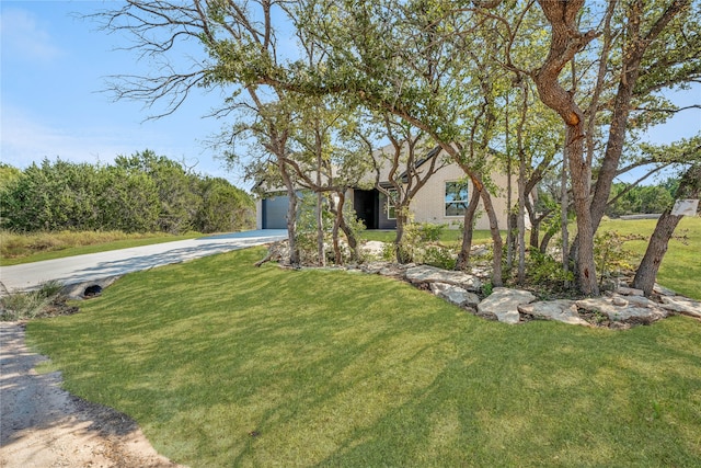 exterior space featuring a front lawn and a garage