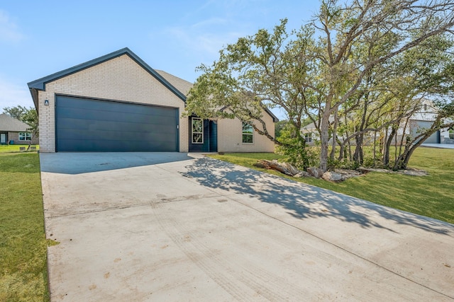 view of front of house with a front yard and a garage