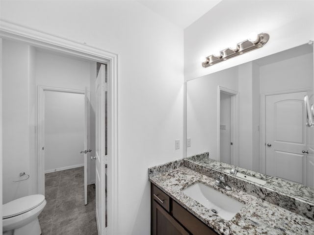 bathroom featuring toilet and vanity