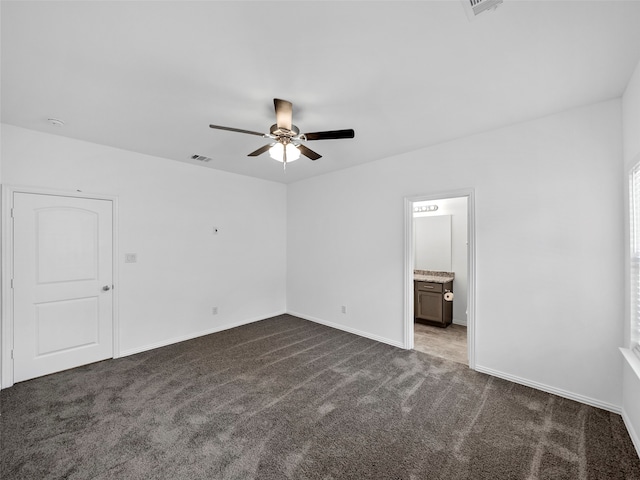 unfurnished room featuring ceiling fan and dark colored carpet