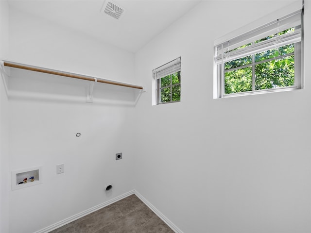 laundry room with hookup for a washing machine, electric dryer hookup, and tile patterned floors