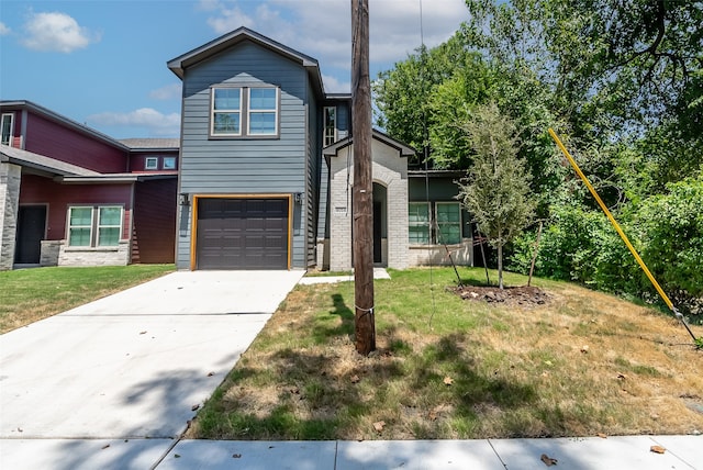 view of front of property featuring a front lawn and a garage