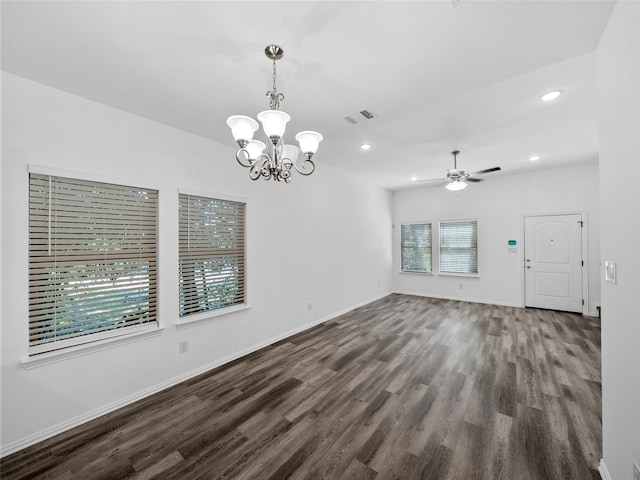 interior space featuring dark hardwood / wood-style floors, a healthy amount of sunlight, and ceiling fan with notable chandelier