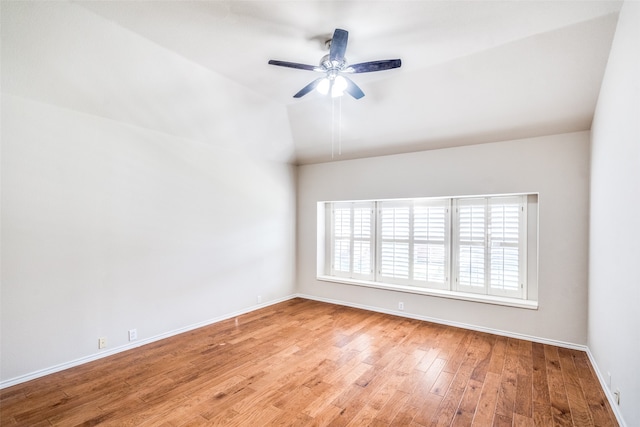 spare room featuring light hardwood / wood-style flooring, ceiling fan, and vaulted ceiling