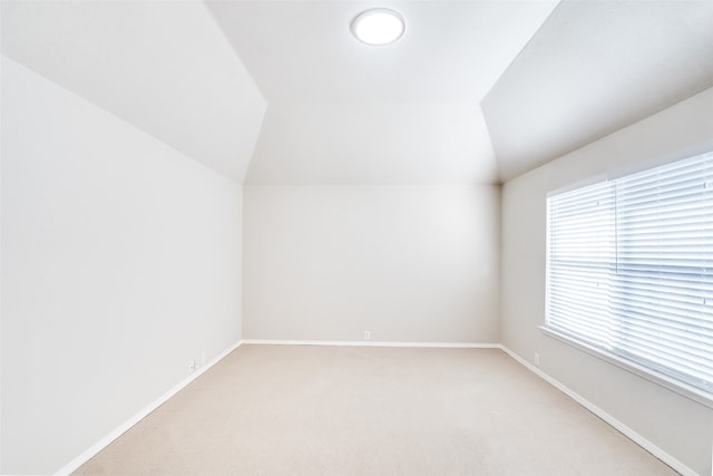 bonus room featuring light colored carpet and vaulted ceiling