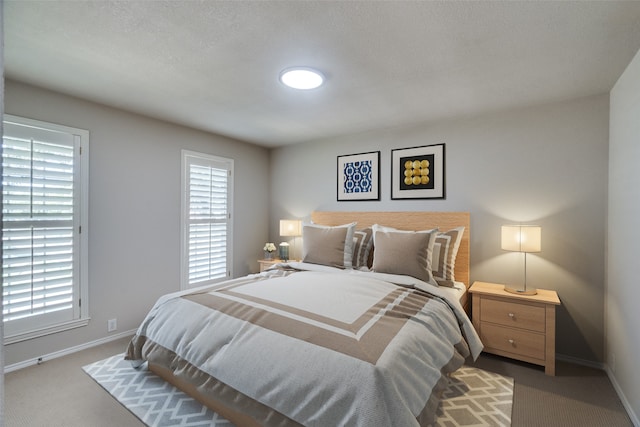 carpeted bedroom featuring a textured ceiling