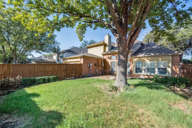 back of house featuring a patio area and a lawn