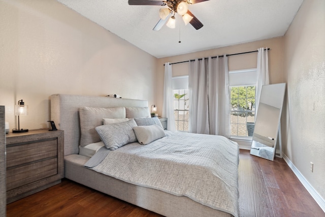 bedroom with ceiling fan and dark hardwood / wood-style flooring