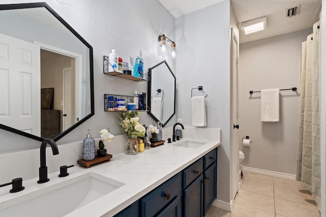 bathroom with tile patterned floors, toilet, a shower with shower curtain, vanity, and a textured ceiling