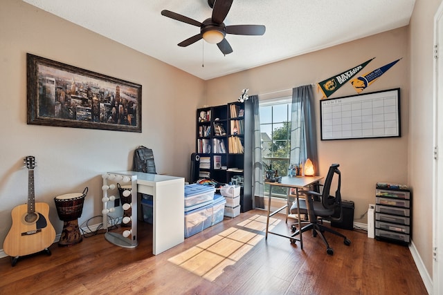 home office with ceiling fan and hardwood / wood-style flooring