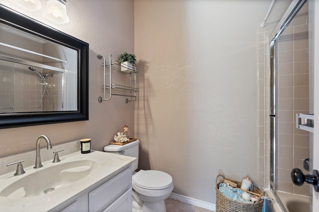 full bathroom featuring vanity, combined bath / shower with glass door, and toilet