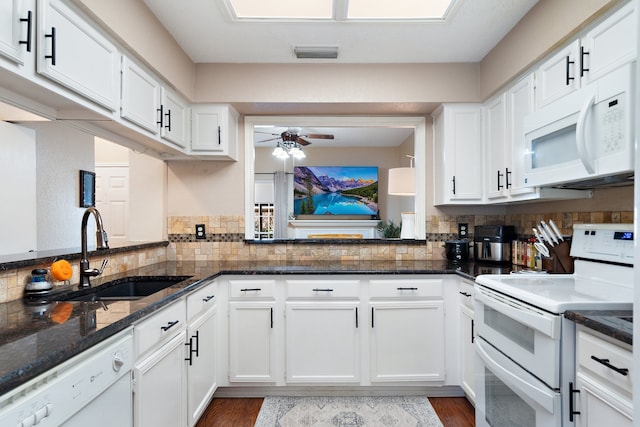 kitchen with white cabinets, sink, dark wood-type flooring, and white appliances