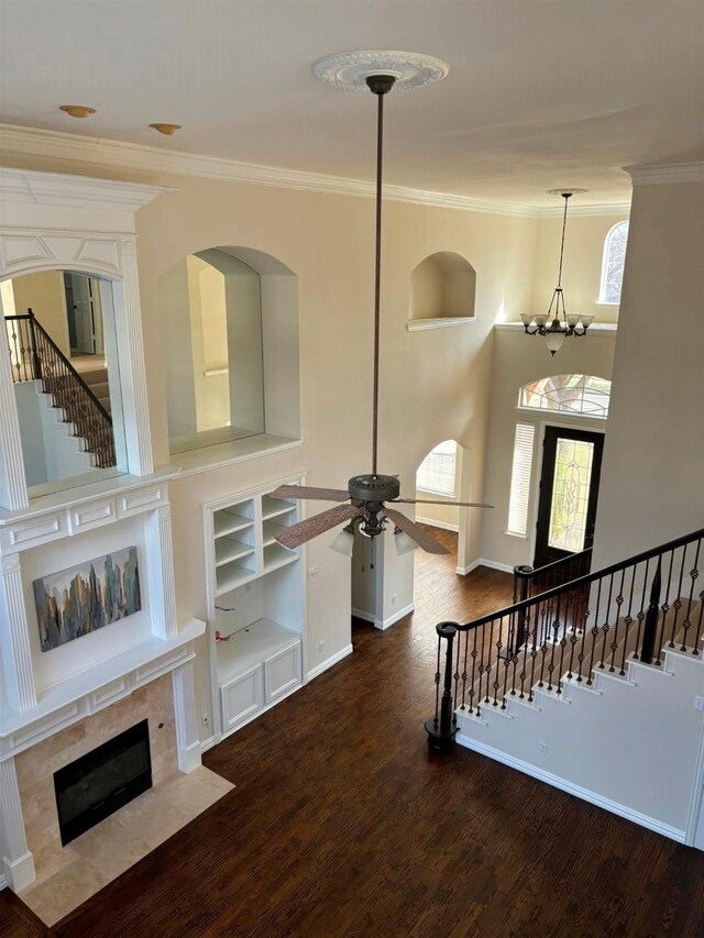 unfurnished room featuring crown molding, light carpet, high vaulted ceiling, and ceiling fan