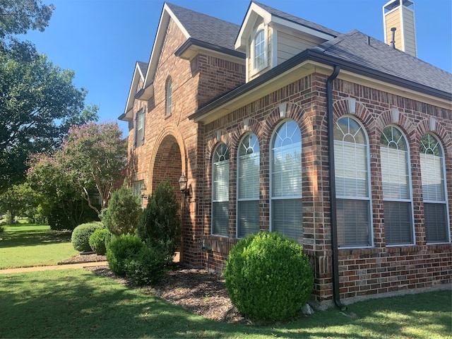 view of home's exterior with a yard